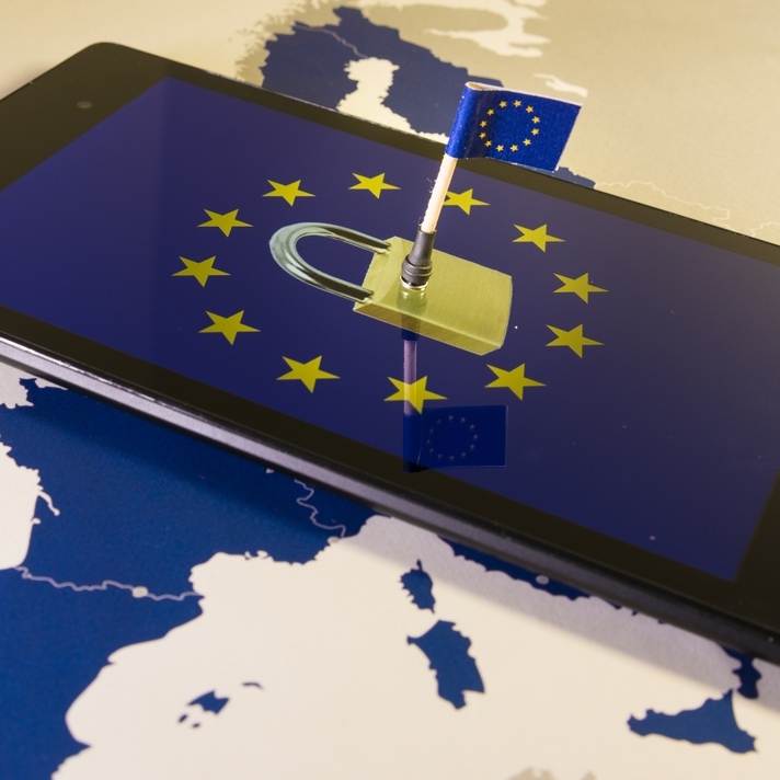 Padlock and EU flag on the screen of a smartphone laying on top of a EU map as a gdpr metaphor